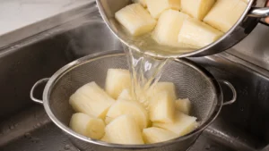 Draining the Cooked Yuca